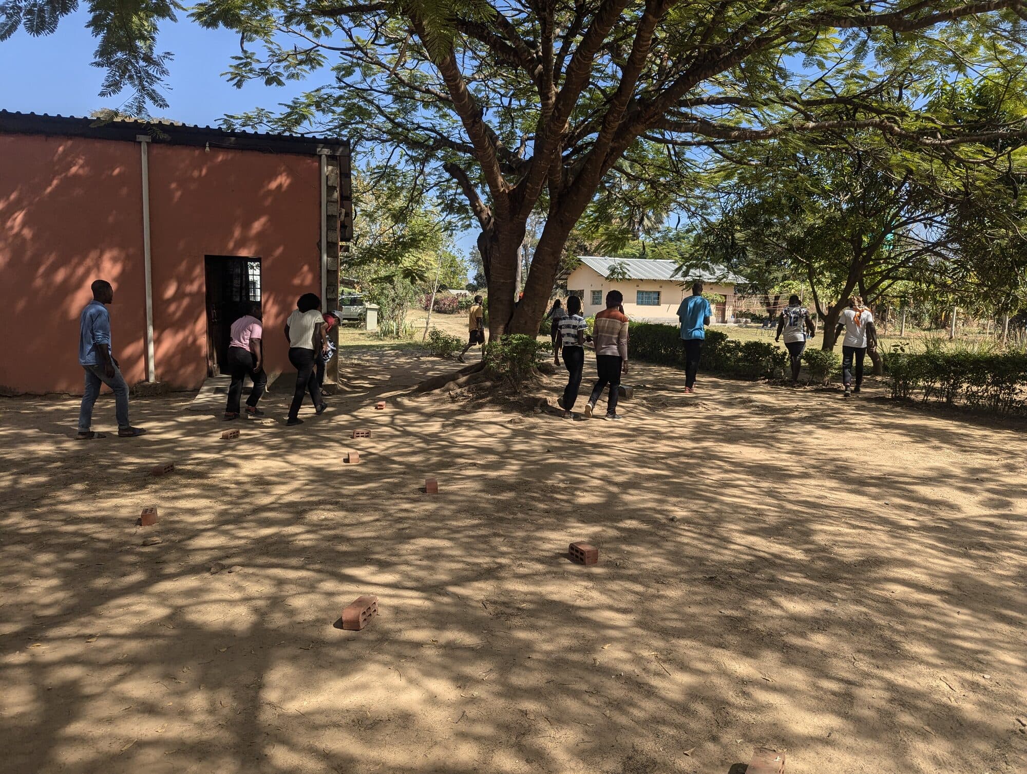 Students and staff walking together through the YWAM Lusaka base grounds