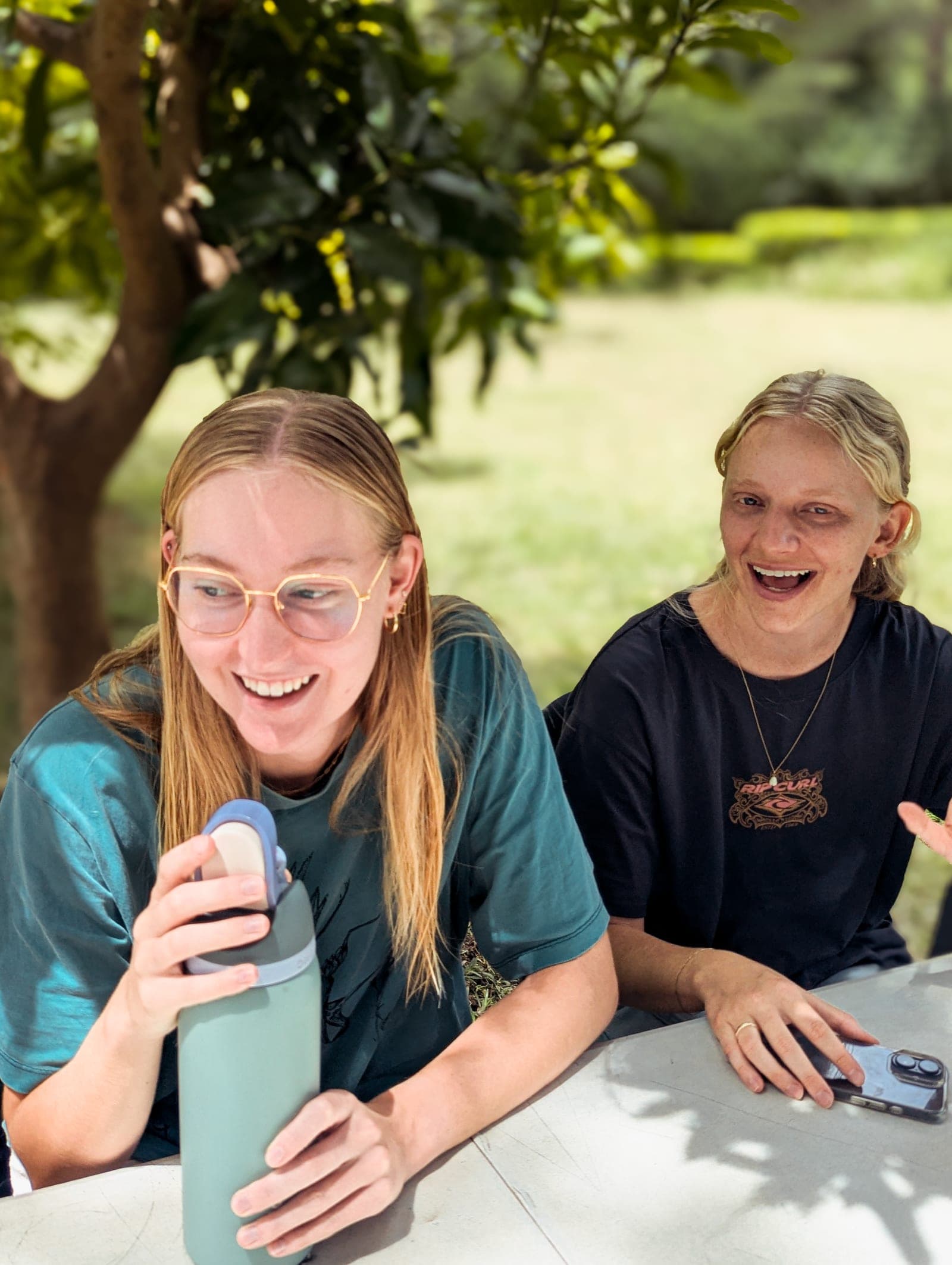 Two members of the Birth Attendant School team laughing together at the base